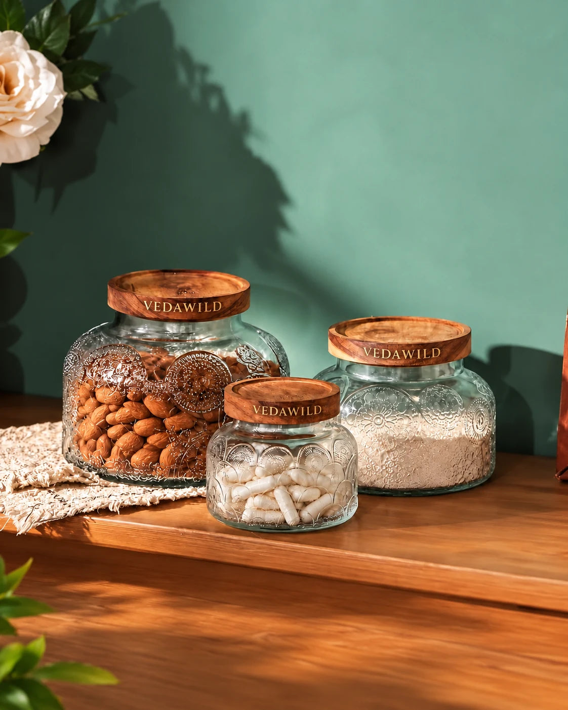 Glass jars of nuts, grains and capsules with VedaWild wooden lids